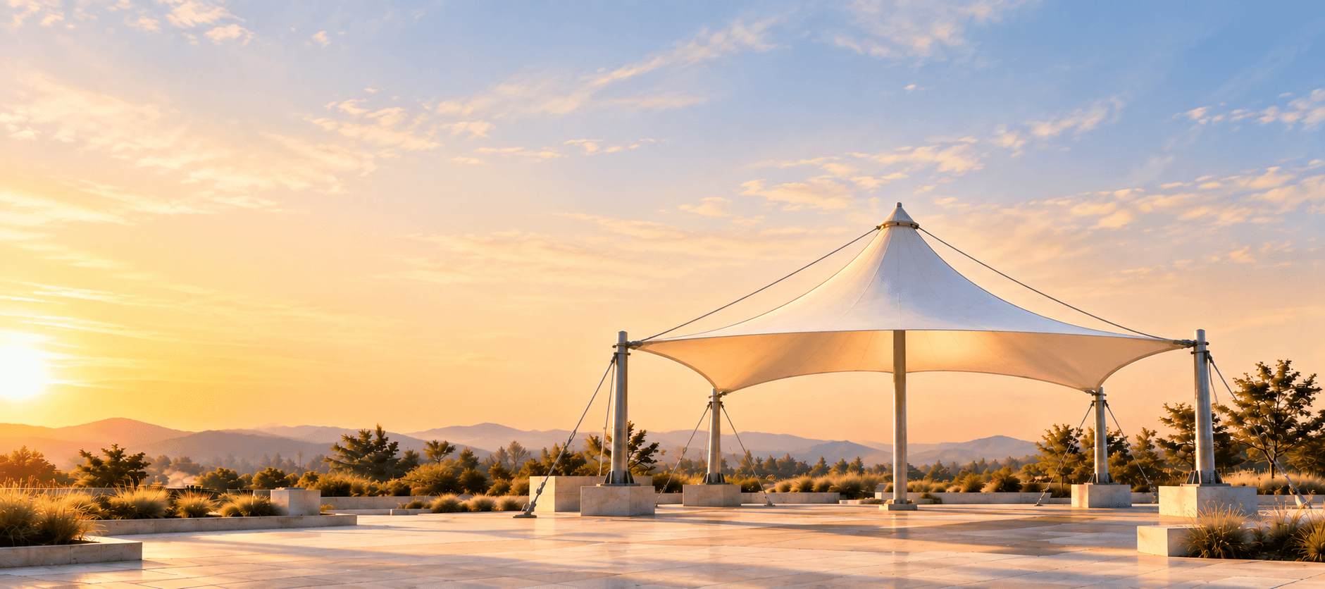 Sculptural white tensile canopy set in a landscaped architectural space
