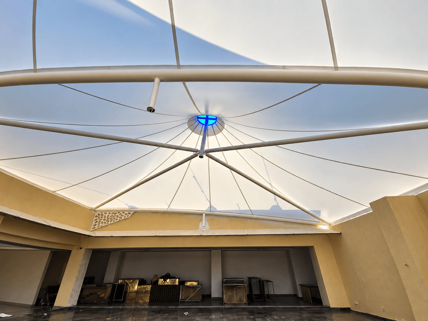 Interior view of the conical fabric roof and radial framing at Madhur Banquets, Jalna