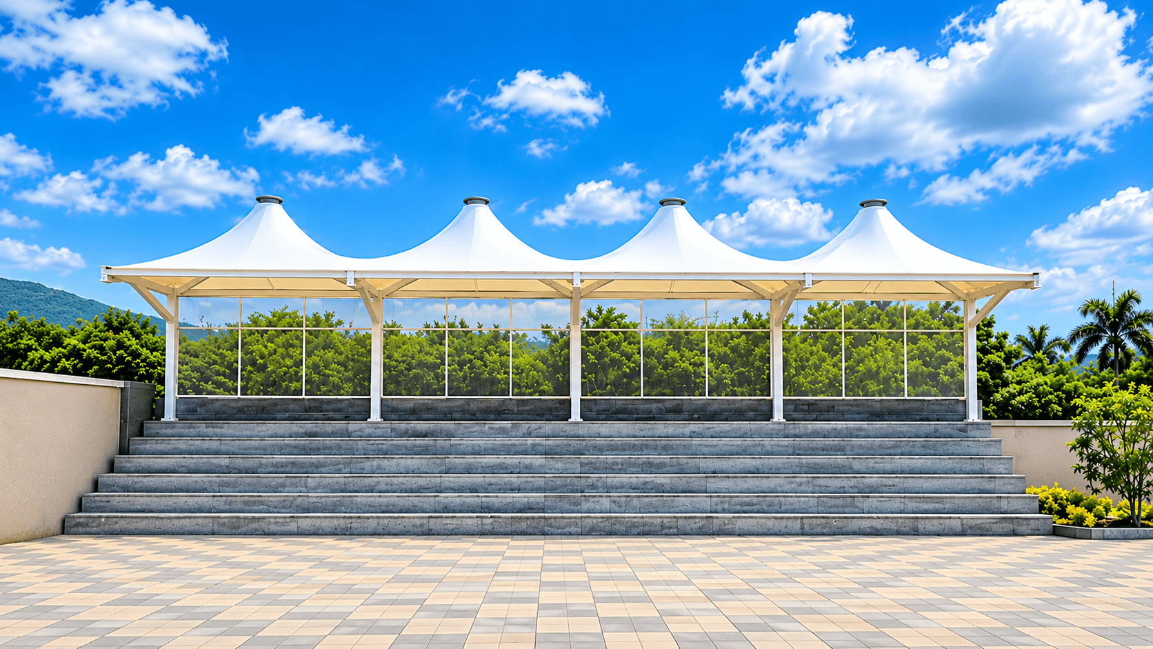 A row of conical fabric roof peaks above stepped seating at New English High School, Landewadi