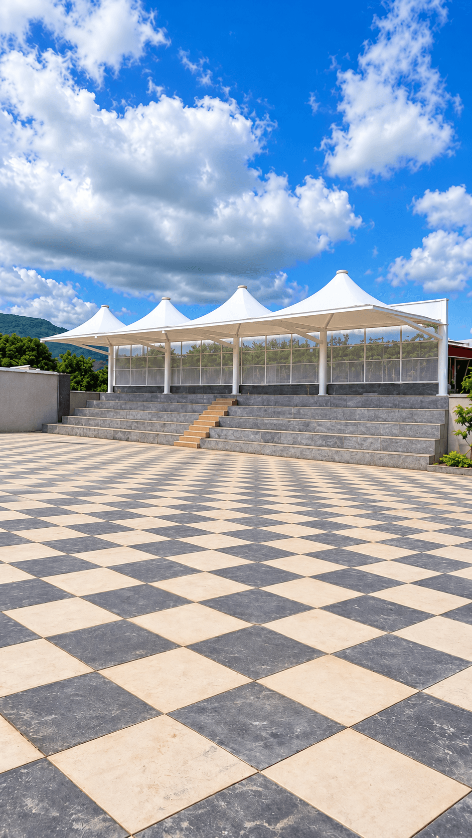 Oblique view of the Landewadi school canopy showing conical peaks and the surrounding paved area